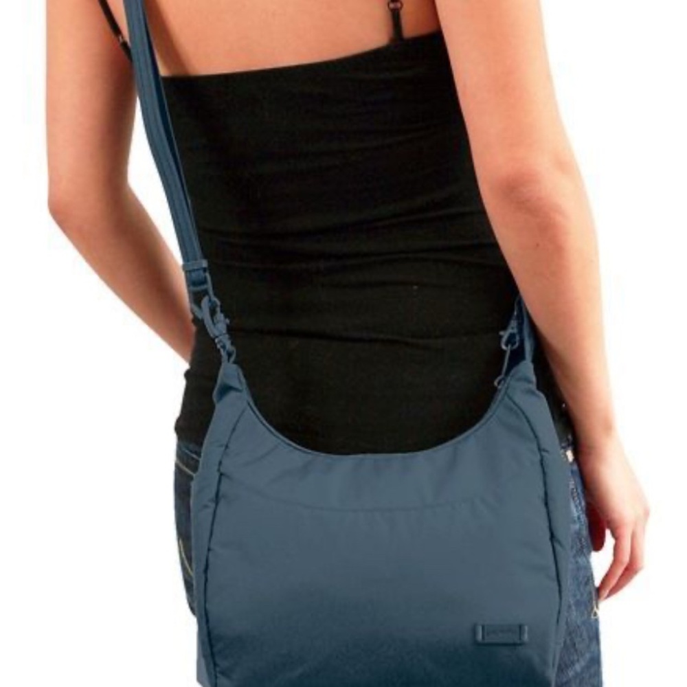 Pacsafe Teal crossbody pickpocket resistant bag. Gently Used